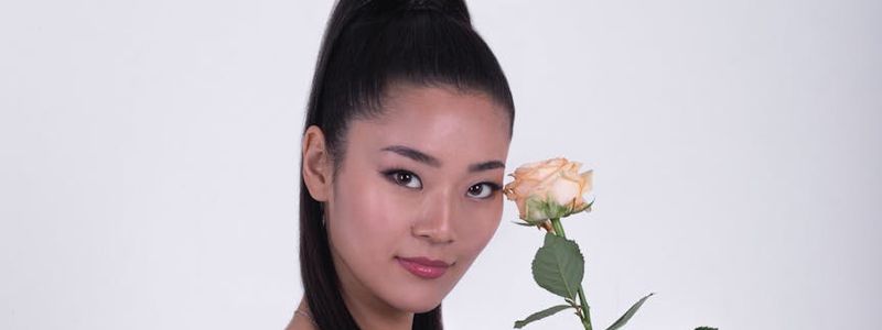 Person performing a bridge pose on a white mat.